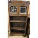 An oak open bookcase with glazed top W.61cm