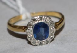 A 1920's 18ct gold, sapphire and diamond cluster ring, size F.