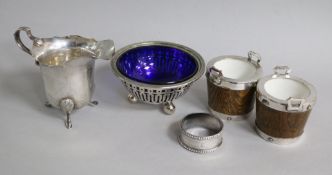 A pair of silver mounted condiments modelled as two handled buckets, a silver cream jug, bowl and