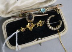 Four assorted early 20th century gold brooches and a stock pin.