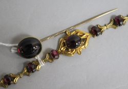 A Victorian gold and cabochon almandine garnet set bracelet and a similar stick pin.