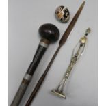 A Knobkerrie, a spear, a figure and a stone