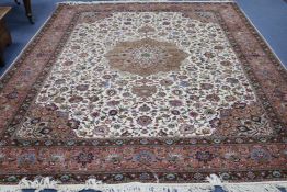 A Tabriz cream ground medallion carpet 400 x 305cm