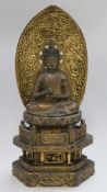 A Japanese lacquer seated figure of Buddha