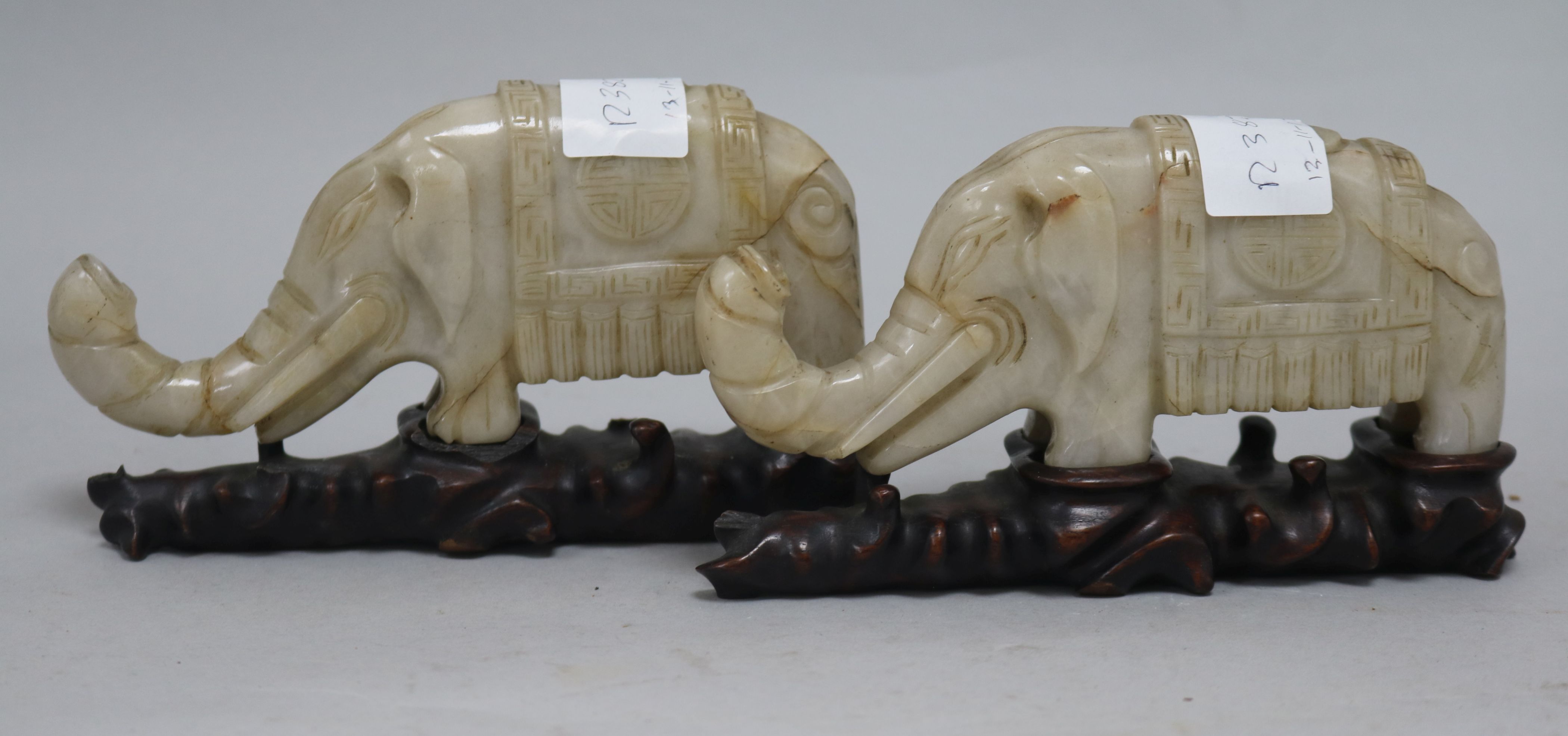 Two carved hardstone elephants on stands