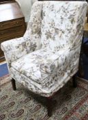 A George III mahogany wing armchair, with squared tapered legs