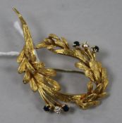 An 18ct gold, sapphire and diamond set foliate brooch, 50mm.