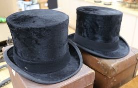 Two moleskin top hats, boxed