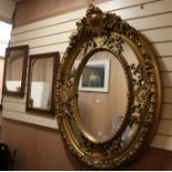 An oval gilt framed mirror W.96cm