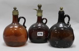 Three Victorian amber glass decanter flagons