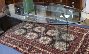 An oval glass centre table, 230cm, faults