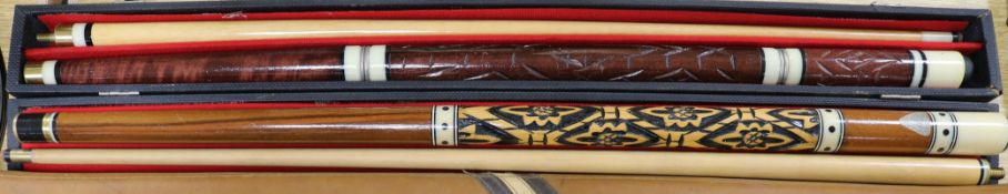 Two snooker cues, cased