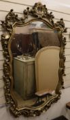 A cartouche shaped gilt framed mirror and another smaller W. 92cm, W.45cm