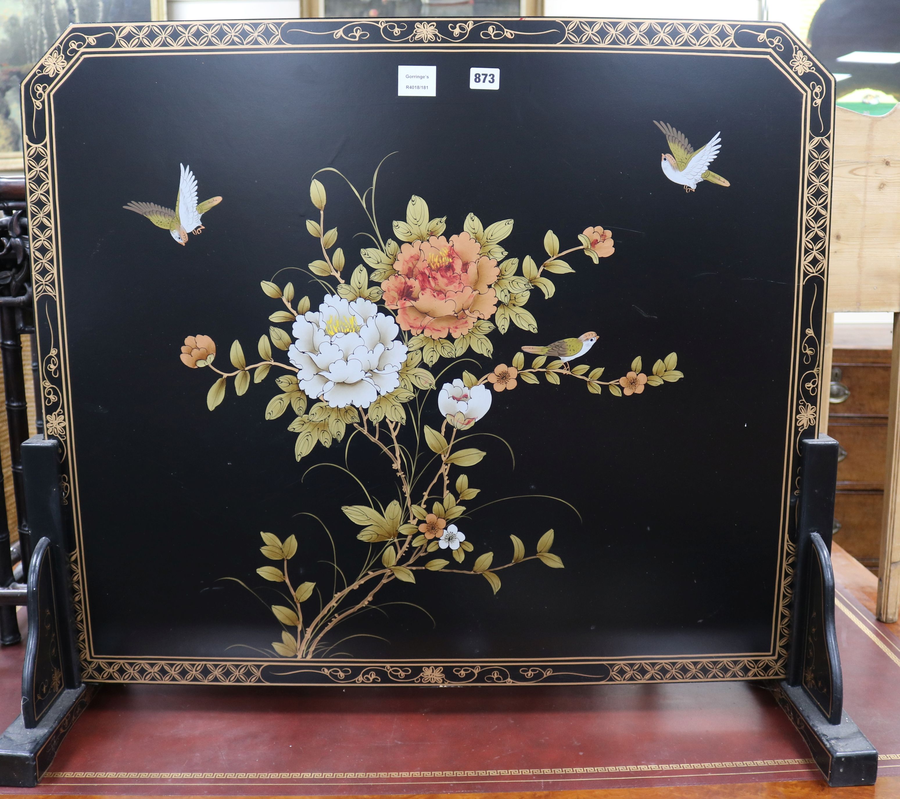 A Chinese black lacquered floral decorated fire screen W.93cm