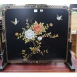 A Chinese black lacquered floral decorated fire screen W.93cm
