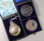 Three cased late 19th/early 20th century St. Bernard dog related medallions including silver.