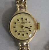 A lady's 9ct gold Fleurier manual wind wrist watch, on a 9ct gold fancy link bracelet.