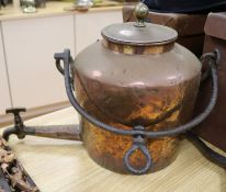 A large 19th century copper hot water urn with wrought iron pot hanger