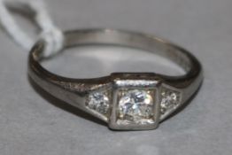 A platinum and three stone diamond ring, size K.