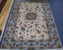 A Tabriz cream ground rug, 245cm x 131cm