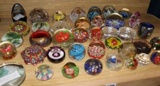 A large collection of glass paperweights