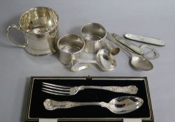 A cased George V silver Christening pair and other silver items including napkin rings,