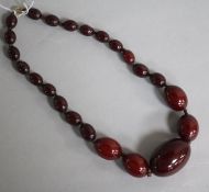 A single strand graduated simulated cherry amber bead necklace, gross 56 grams, 38cm.