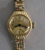 A lady's 9ct gold Avia manual wind wrist watch on a 9ct gold bracelet.