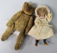 A miniature doll and a teddy bear