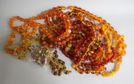 A collection of amber and amber coloured necklaces.
