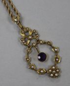 An Edwardian 9ct gold seed pearl and amethyst pendant and yellow metal rope twist chain, pendant