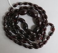 A single strand graduated simulated cherry amber bead necklace, gross 80 grams, 118cm.