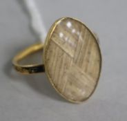 A George III yellow metal (18ct) and enamelled mourning ring with hairpiece in marquise setting (a.