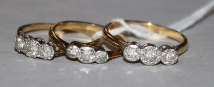 Three gold and three stone diamond rings, two stamped 18ct.