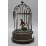 A brass double singing bird in a cage musical box
