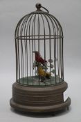 A brass double singing bird in a cage musical box