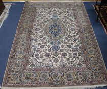 A Tabriz cream ground medallion rug, 230cm x 154cm