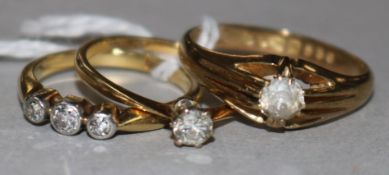 An 18ct gold, platinum and diamond solitaire ring, a similar 9ct ring and an 18ct three-stone