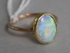 A yellow metal and white opal ring, size M.