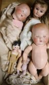 Three bisque head dolls, a peg doll and a miniature doll