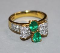 An emerald and diamond bow-shaped ring with diamond-set shoulders, 18ct yellow gold shank, size K.