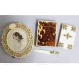 A carved ivory circular frame, an ivory page marker, a French aide memoir and a tortoiseshell card