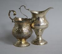 Two George III silver cream jugs, one by WK, London, 1766, tallest 12cm.