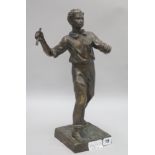 A bronze figure of a tennis player