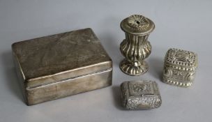 A silver cigarette box, two small boxes including Dutch silver and a silver pepperette.