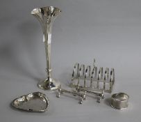 A small group of silver including a toast rack, posy vase, counter dish and a pair of knife rests