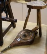 A pair of bellows and a stool