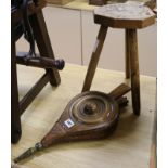 A pair of bellows and a stool