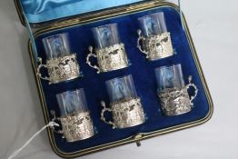 A late Victorian cased set of six repousse silver cup holders by William Comyns, Birmingham, 1891,