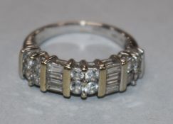 An 18ct white gold and diamond half hoop ring set with five cluster of round or baguette cut stones,
